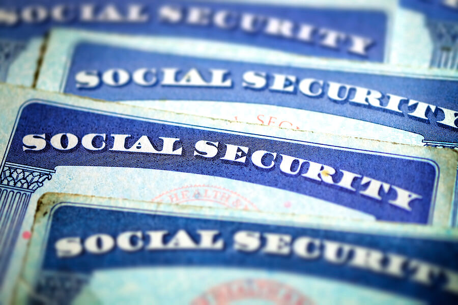 Social Security Cards on a flat surface with only the top of the card showing